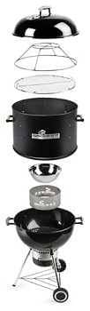 Black Charcoal kettle grill with many additional parts for extra grilling and smoking capability.