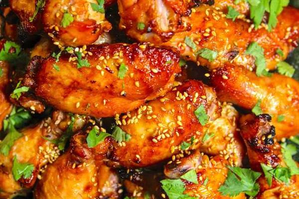 Grilled miso chicken wings topped with sesame seeds and cilantro