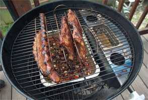 smokenator setup on a charcoal grill using the indirect method