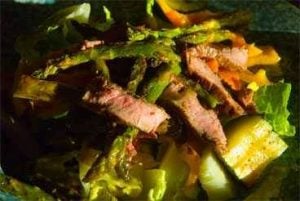 Sliced flanks steak on salad