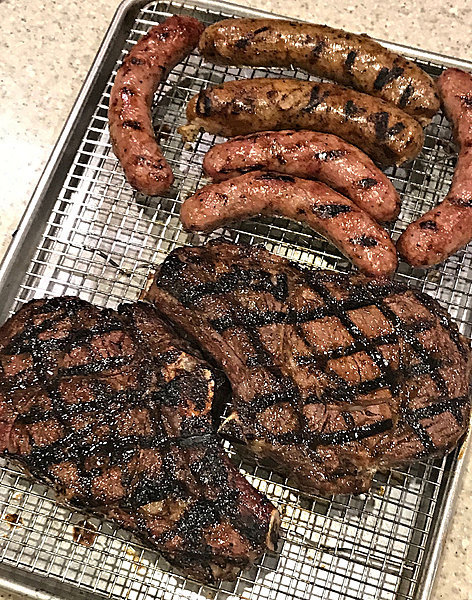 steaks and sausages cooked on sear daddy