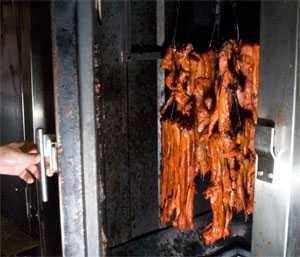 Strips of pork cooking in sun wah oven