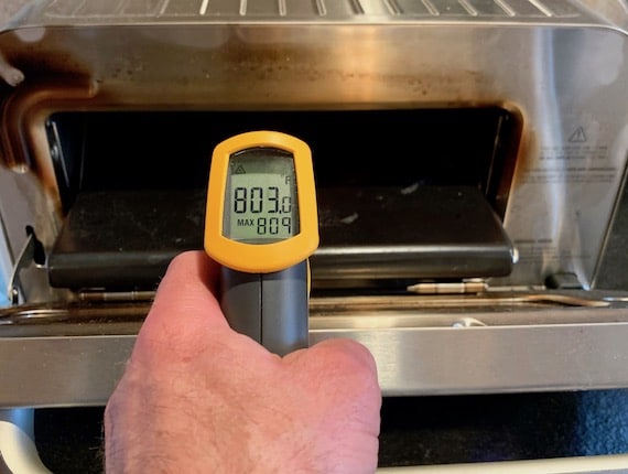 thermometer gun pointed at pizza stone
