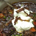 A bowl of chili garnished with sour cream