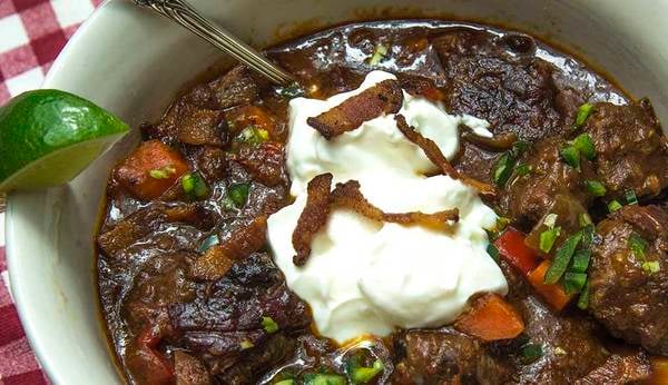 A bowl of chili garnished with sour cream