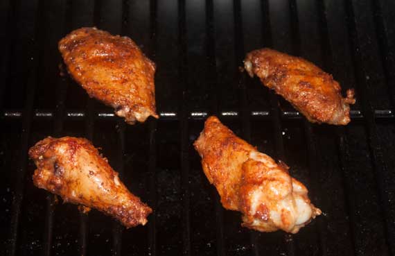 Golden brown chicken wings on a grill