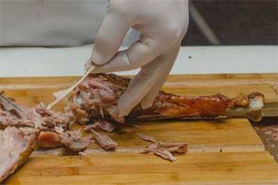 removing bones and tendons from a turkey leg