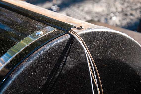 Black metal hood with wires threaded into the interior