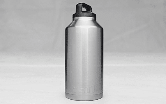 Aluminium Thermos with Hot Drink on Rock Stone Outdoors. Space for