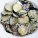 Slices of zucchini and chunks of mushrooms coated in sour cream
