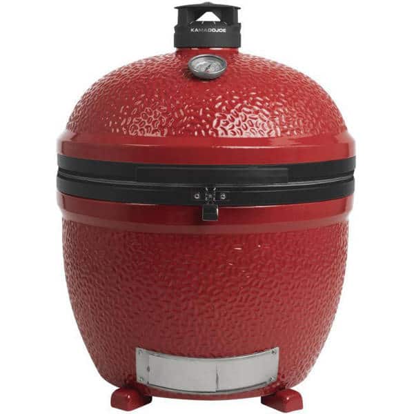 Red kamado placed on a floor with no stand.