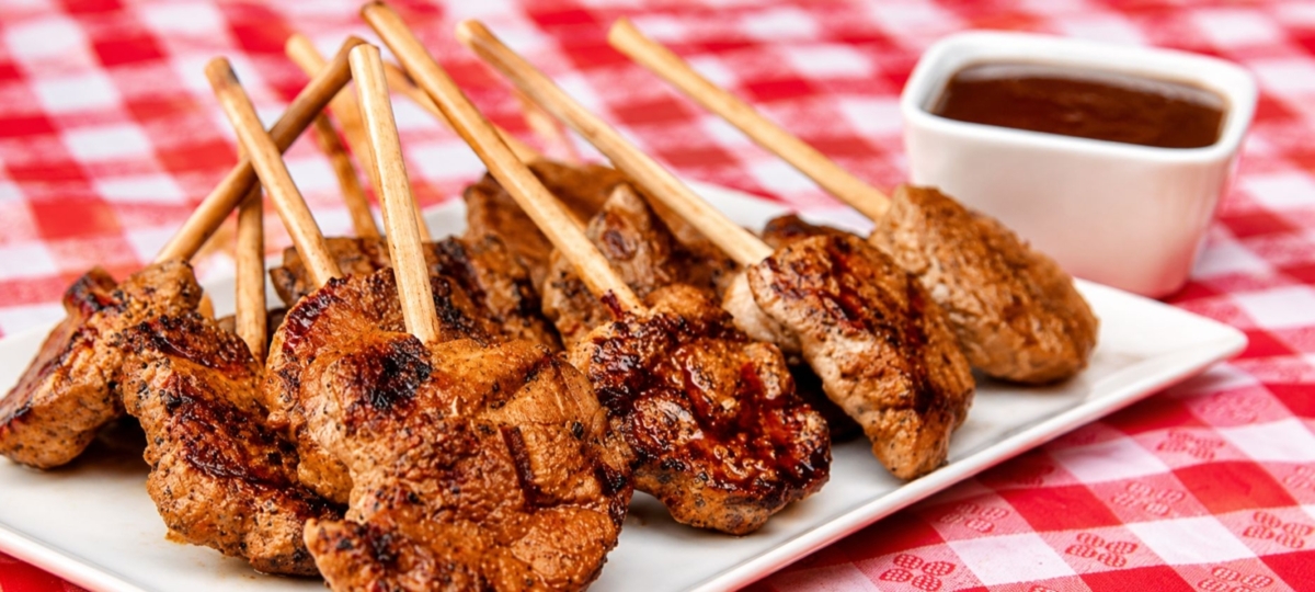 Grilled pork tenderloin lollipops with dipping sauce.