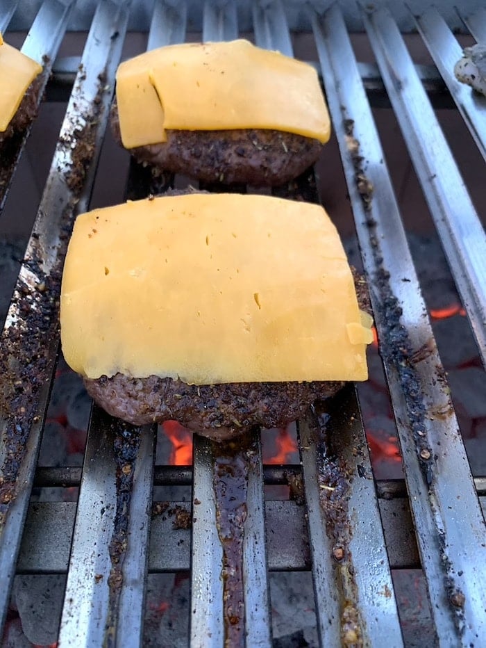 cheeseburgers on grill