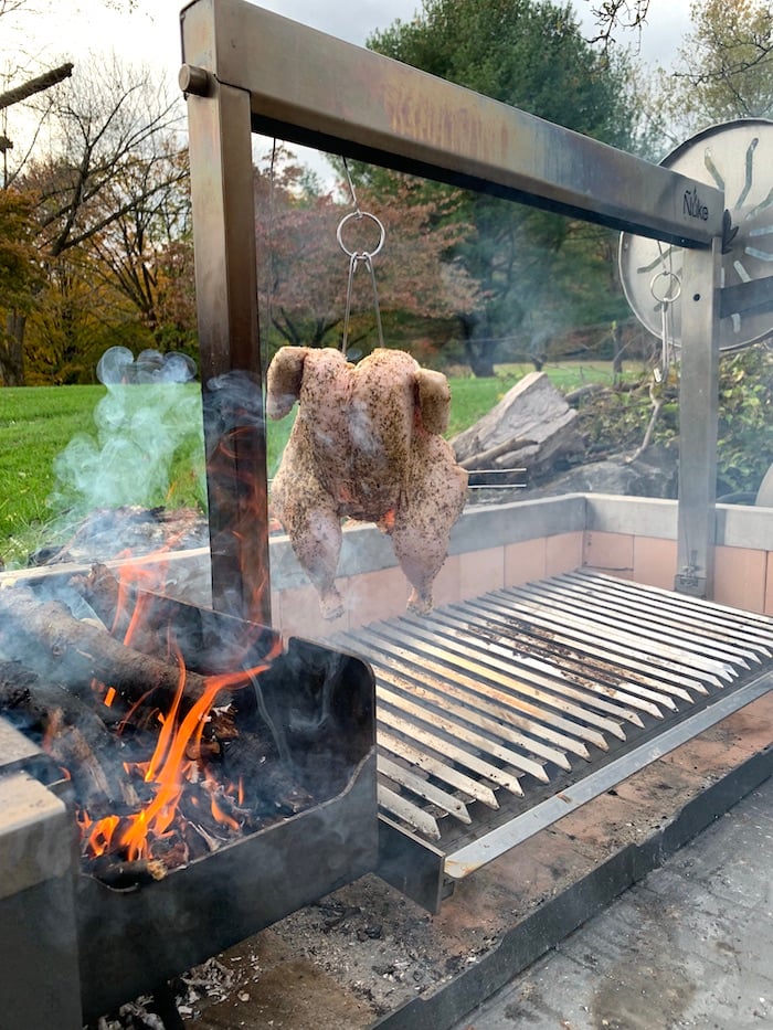 chicken hanging on wood grill