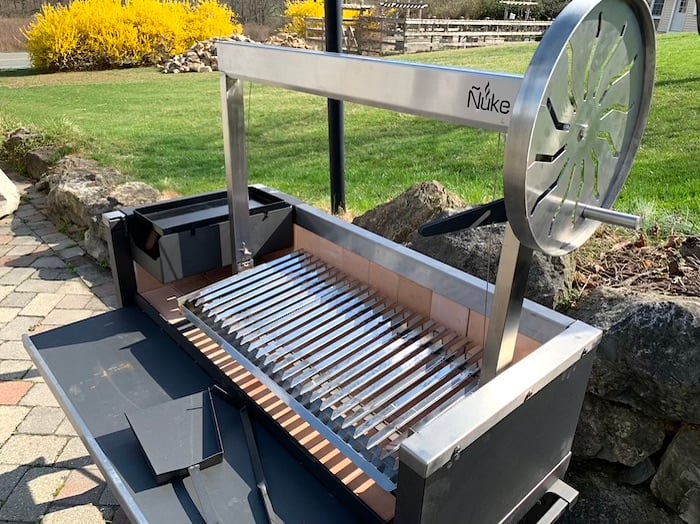 Tradition meets precision with our all-new Argentine grill! Complete with a  heavy-duty adjustable grate, s-hooks for hanging meat and fir