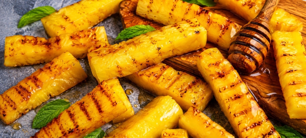 Grilled pineapple sticks drizzled with honey.