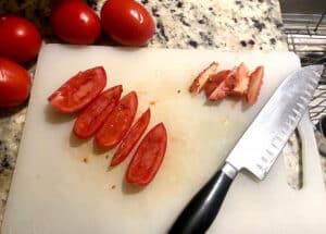 Slicing roma tomatoes.