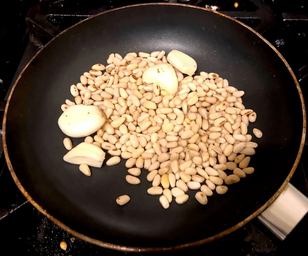 toasting pine nuts and garlic cloves