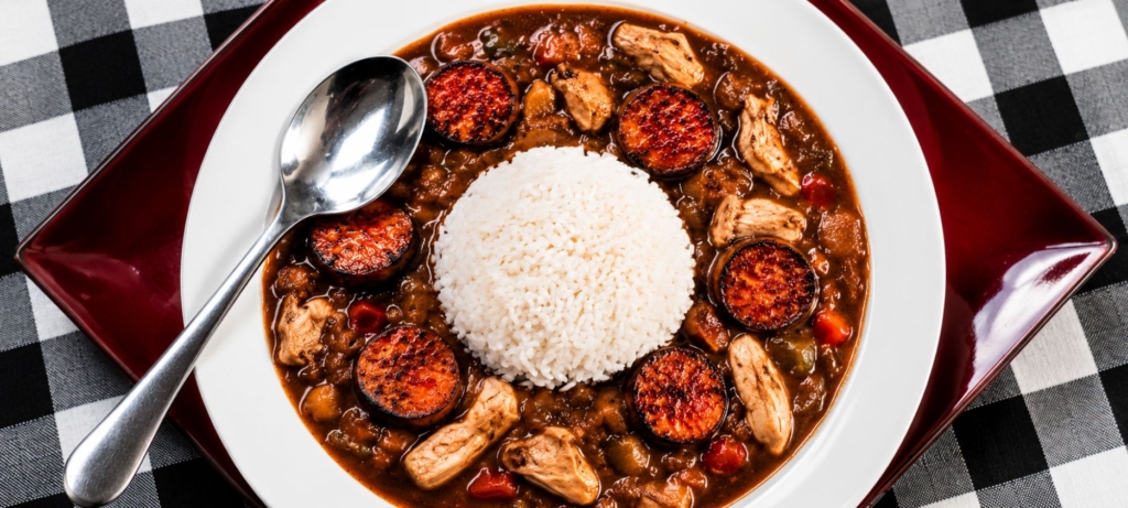 Turkey and sausage gumbo in a bowl with white rice.
