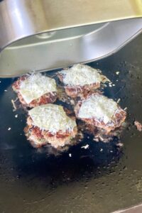 smashed meatballs topped with cheese.