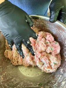 mixing meatball ingredients.