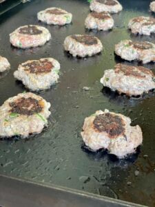 smashed meatballs on griddle.