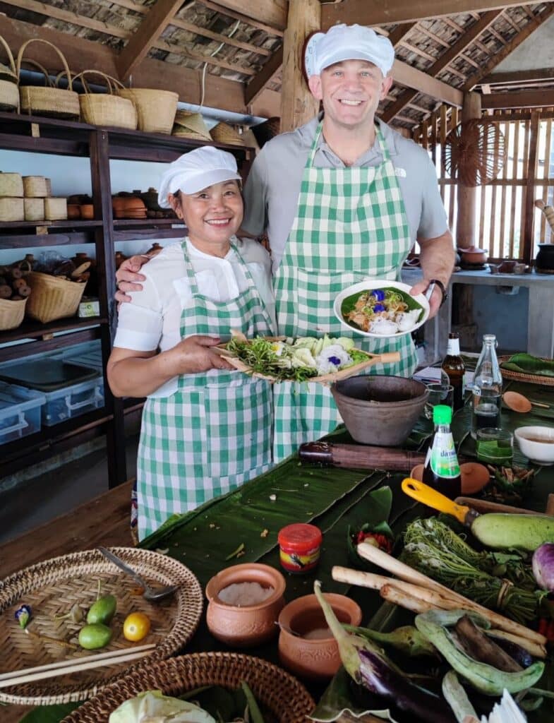 Dan Gertsacov cooking with a woman in Laos