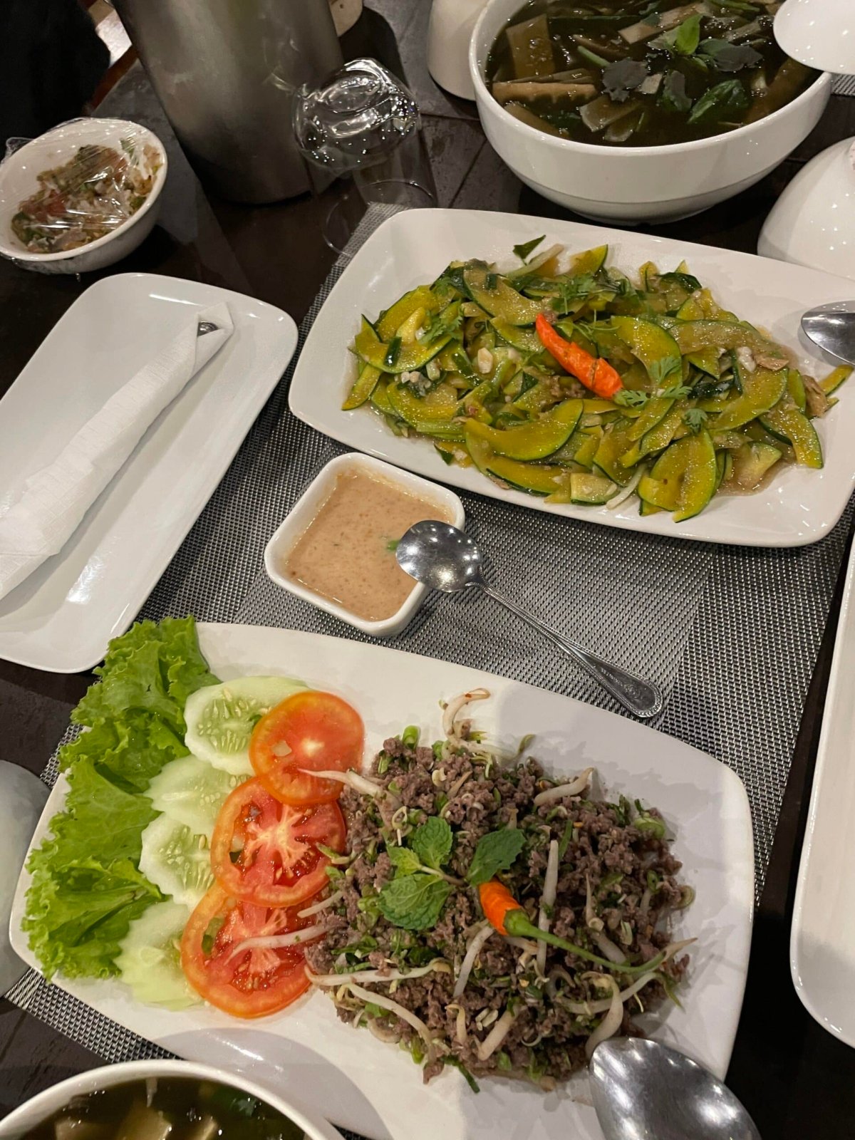 Grilled laap plated with vegetables.