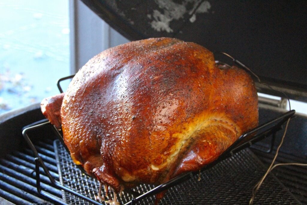 Closeup of whole smoked turkey on grill