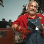 Meathead standing next to a smoker