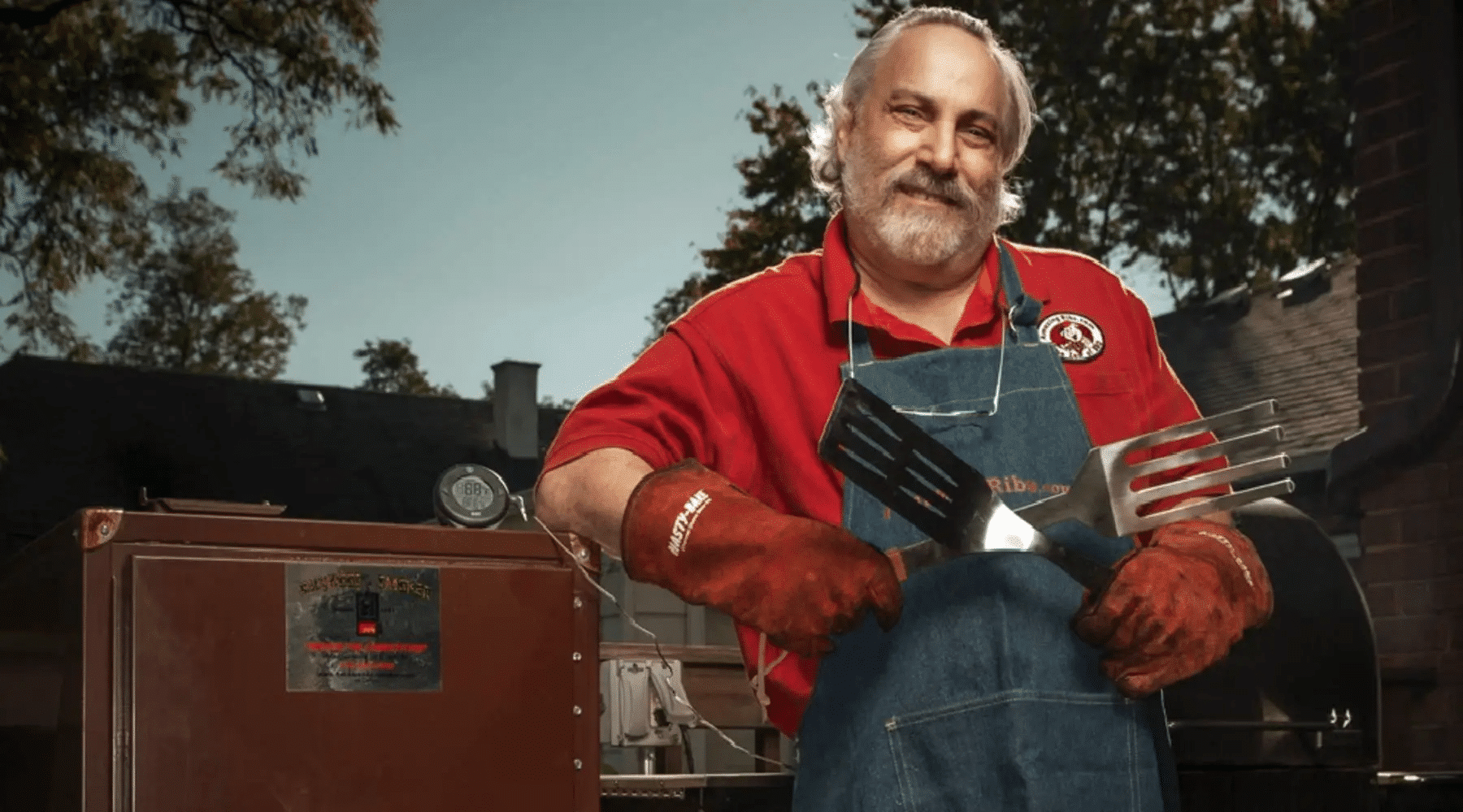 Meathead standing next to a smoker