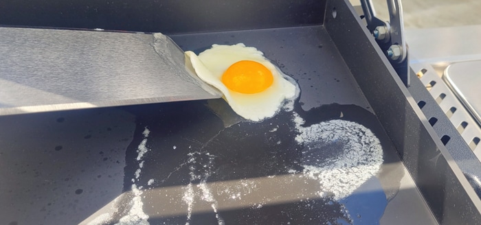 Weber Slate flipping an egg