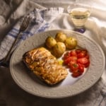 miso maple salmon a la nobu on a plate with potatoes and tomatoes