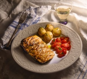 miso maple salmon a la nobu on a plate with potatoes and tomatoes