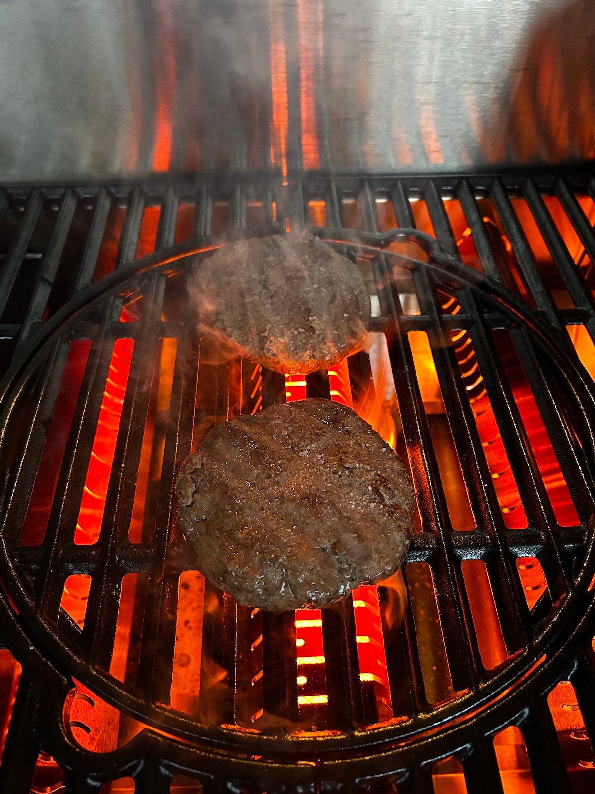 Steakhouse burgers searing on grill