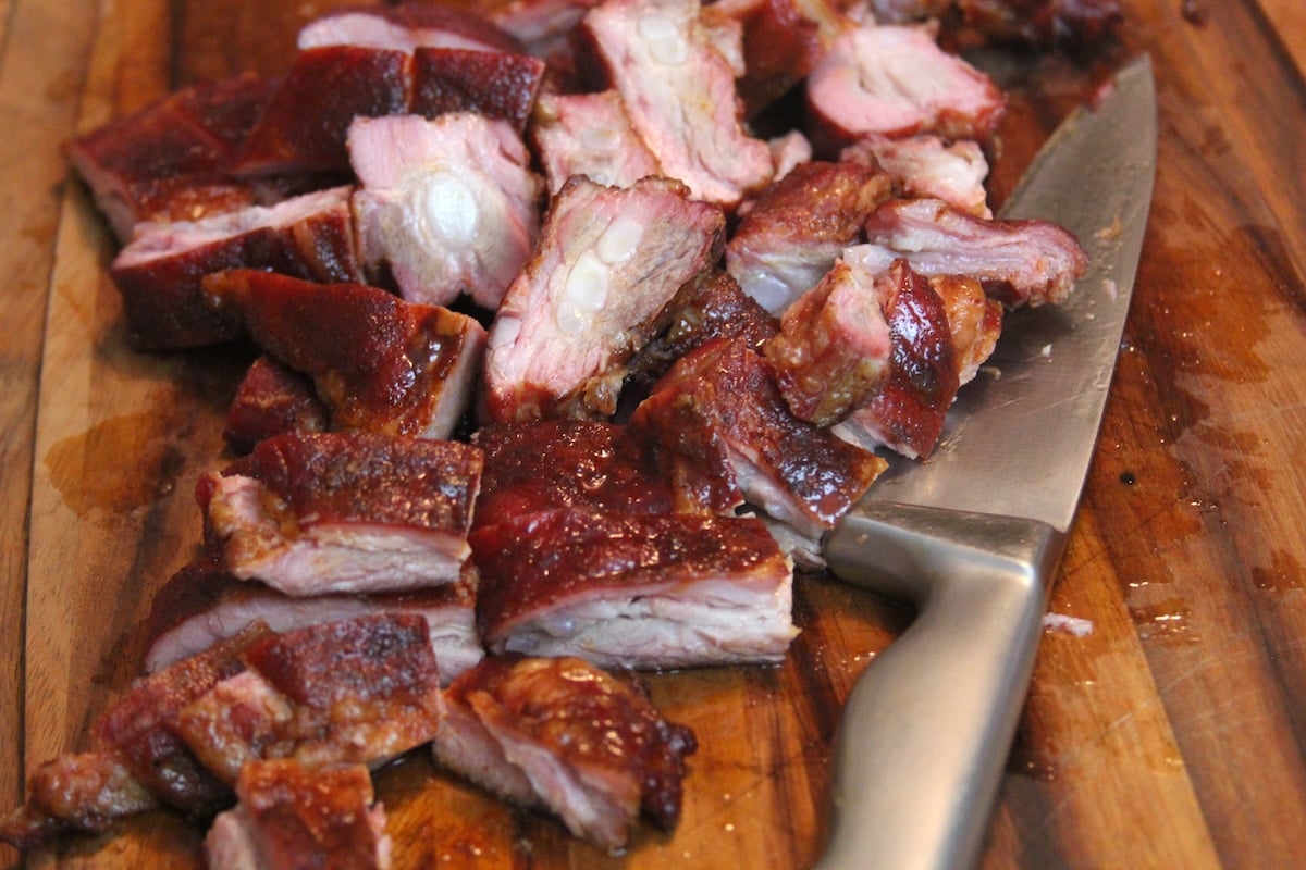 smoked pork rib tips and knife on cutting board