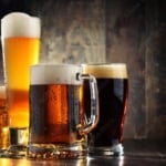 four different beer glasses filled with four different beers