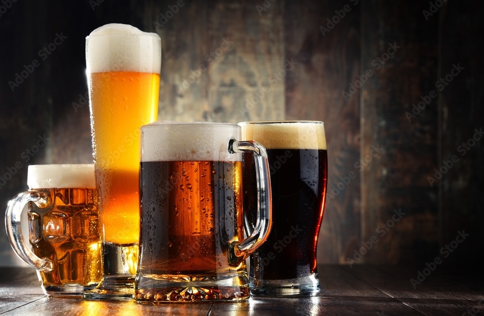 four different beer glasses filled with four different beers