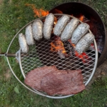 Breeo flank steak and foil wrapped potatoes on the Outpost Grill