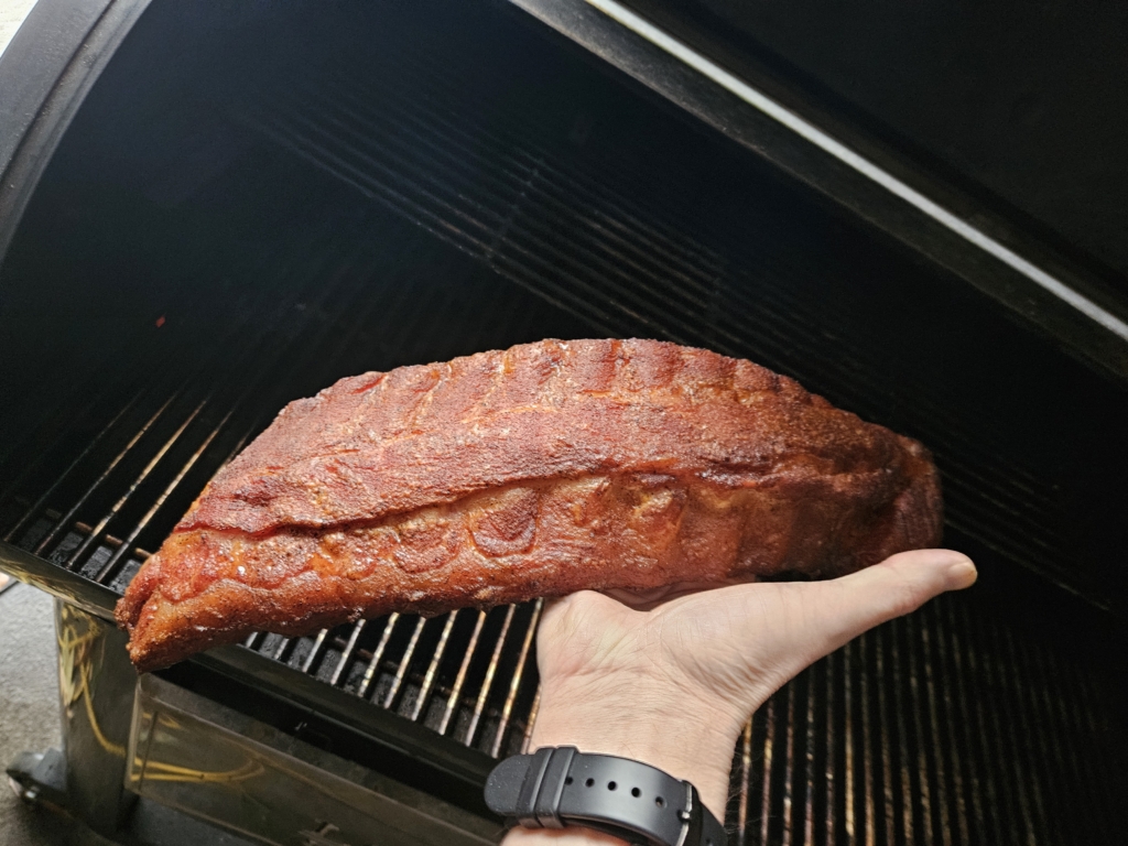 Rack of ribs being held in a hand
