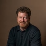 Robert F. Moss headshot seated