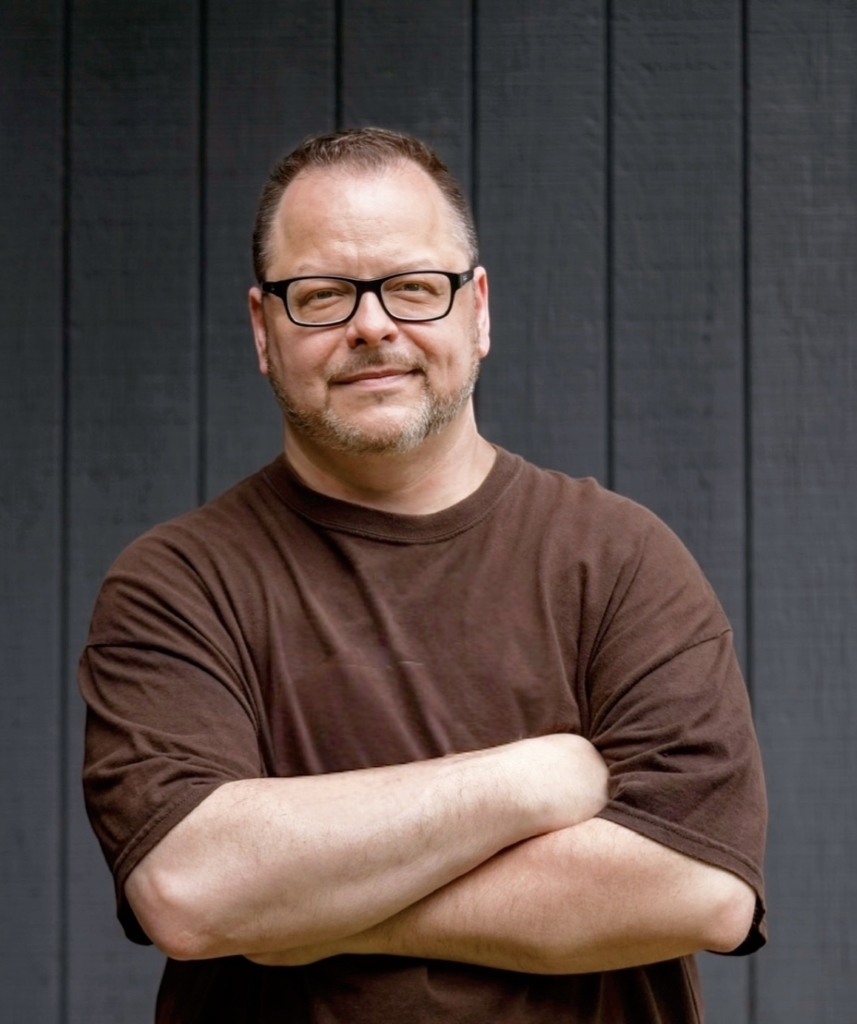 Ray Sheehan standing with arms folded across his chest