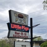 Little Pigs Bar-B-Q sign on a pole