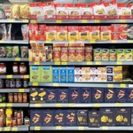 dried pasta and other processed food on shelves in a grocery store.