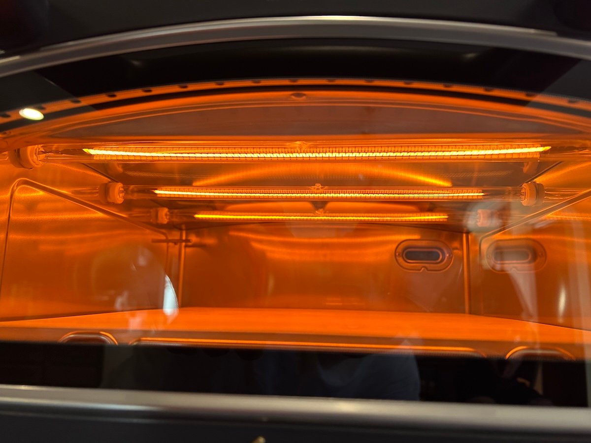 Current Model P Smart Pizza oven interior showing graphene heating elements glowing orange.