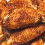 close up of grilled chicken wings with a dry rub