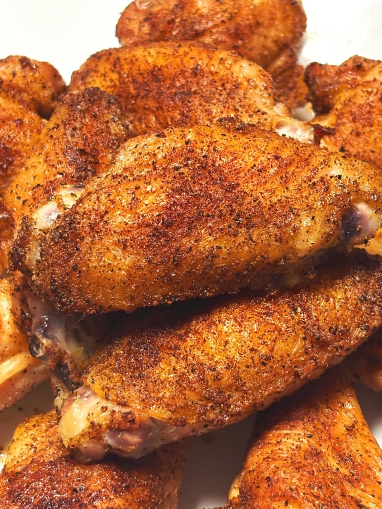 close up of grilled chicken wings with a dry rub