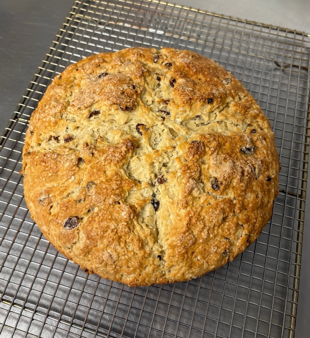 Irish soda bread on a wire cooling rack.