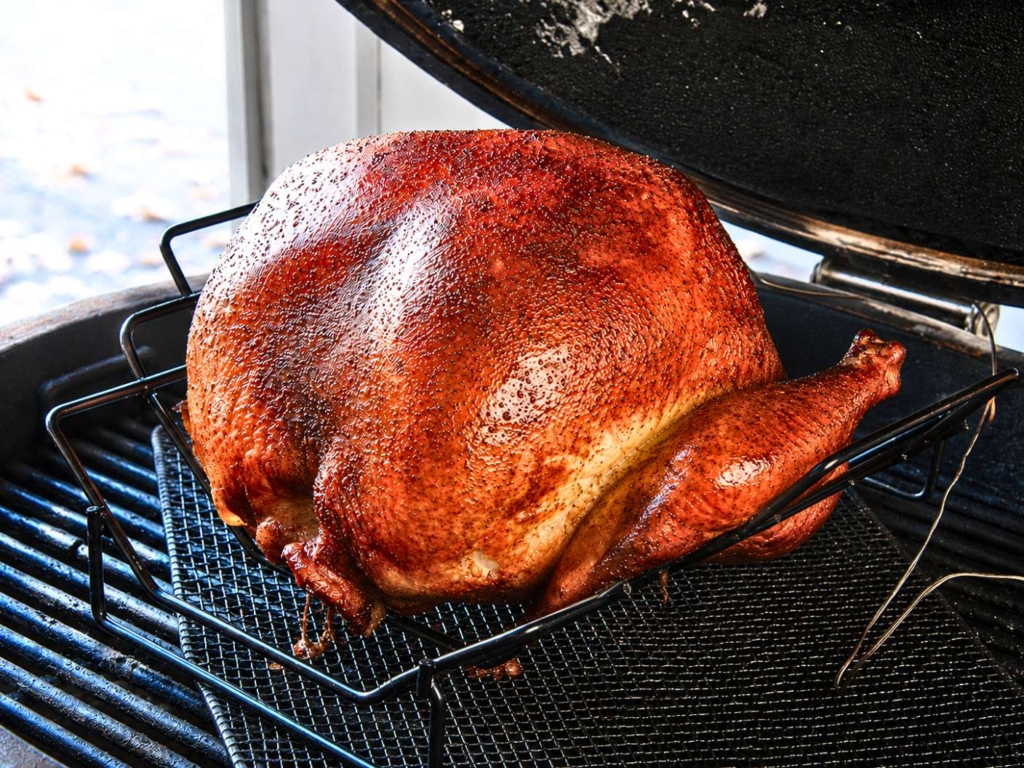 Closeup of whole smoked turkey on grill