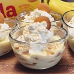 Banana pudding in glass bowls topped with whipped cream